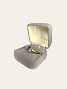 14K yellow gold entourage ring set with sky blue topaz and brilliant cut diamonds