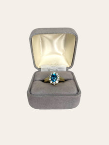 14K yellow gold entourage ring set with sky blue topaz and brilliant cut diamonds